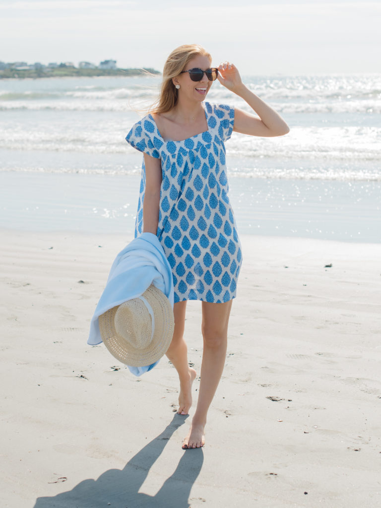 a tan redhead on the beach in NavyBleu resort collection coverup